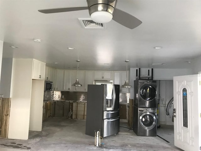 kitchen with stainless steel fridge with ice dispenser, stacked washer / drying machine, ceiling fan, white cabinetry, and decorative light fixtures