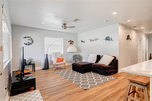 living room featuring ceiling fan and hardwood / wood-style floors