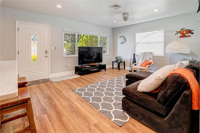 living room featuring ceiling fan and hardwood / wood-style floors