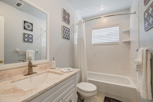 full bathroom with tile patterned flooring, toilet, vanity, and shower / bath combo