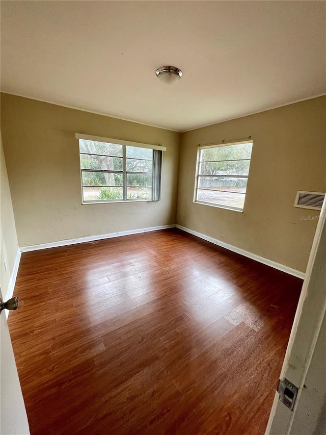 unfurnished room with dark wood-type flooring