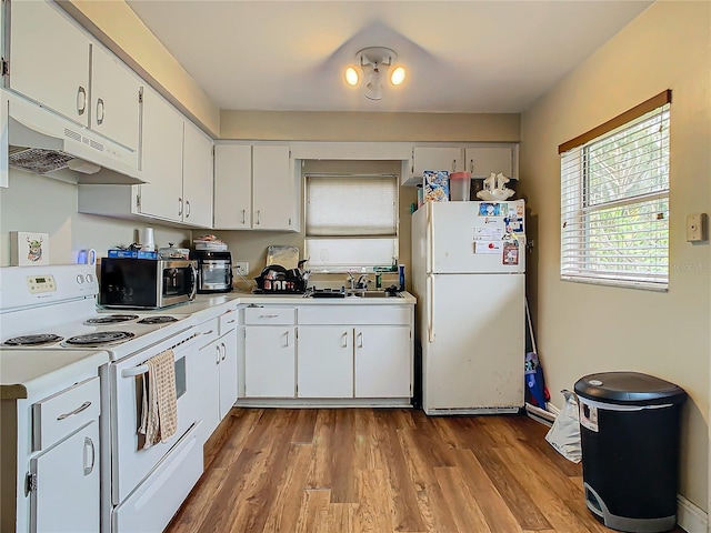 kitchen featuring sink, white cabinets, white appliances, and light hardwood / wood-style floors