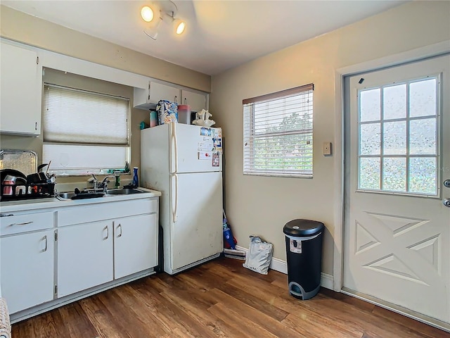 kitchen featuring white fridge, sink, white cabinets, and dark hardwood / wood-style flooring