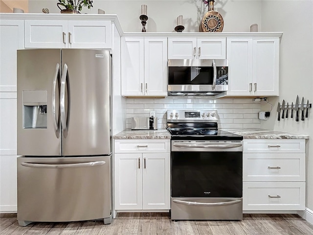 kitchen with appliances with stainless steel finishes and white cabinetry