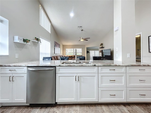 kitchen featuring ceiling fan, white cabinetry, lofted ceiling, and dishwasher