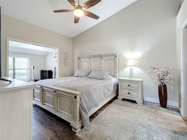 bedroom with ceiling fan, hardwood / wood-style flooring, and vaulted ceiling