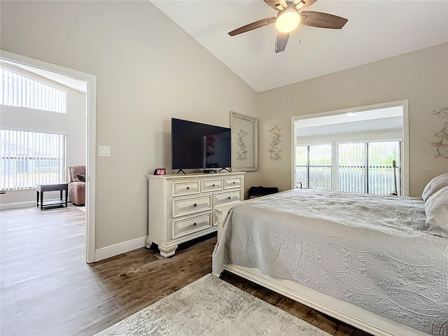 bedroom with ceiling fan, hardwood / wood-style flooring, multiple windows, and lofted ceiling