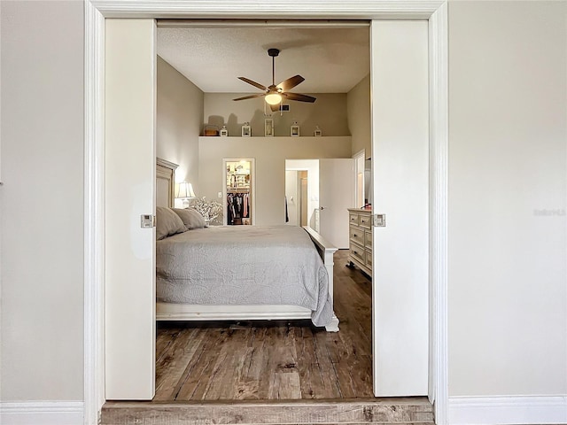 bedroom with ceiling fan and hardwood / wood-style flooring