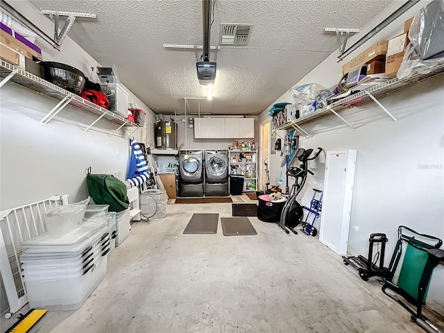 garage featuring a garage door opener, washer and dryer, and electric water heater