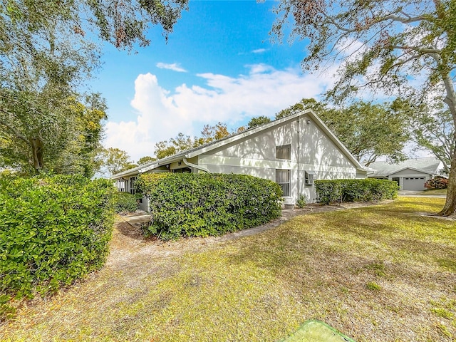 view of side of property featuring a yard