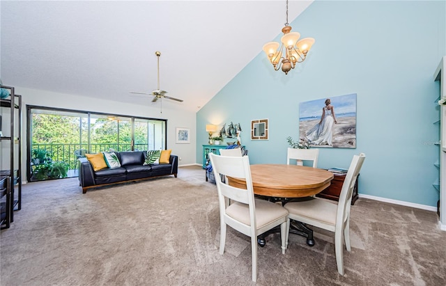 dining space featuring carpet, ceiling fan with notable chandelier, and high vaulted ceiling