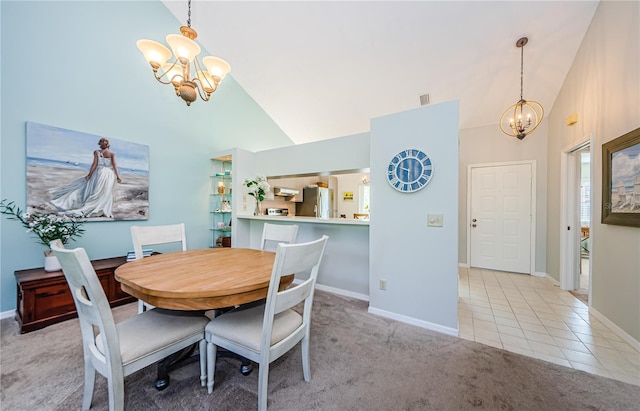 carpeted dining area with high vaulted ceiling and an inviting chandelier