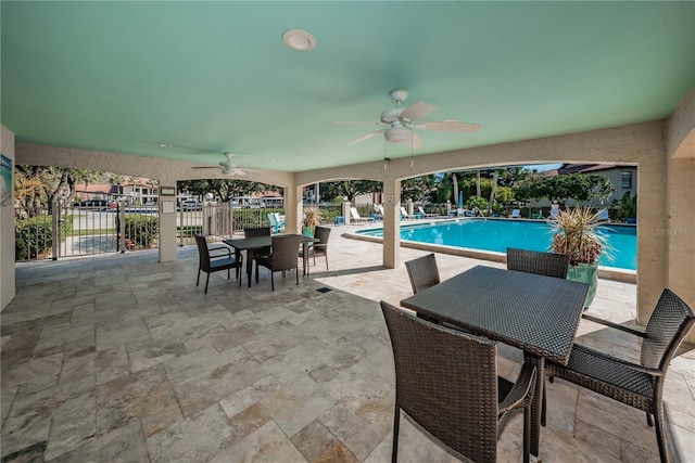 view of patio with ceiling fan and a community pool