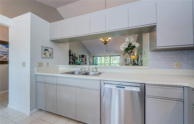 kitchen featuring stainless steel dishwasher, ceiling fan, sink, white cabinets, and lofted ceiling