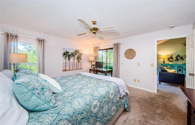 carpeted bedroom with ceiling fan, a textured ceiling, and multiple windows