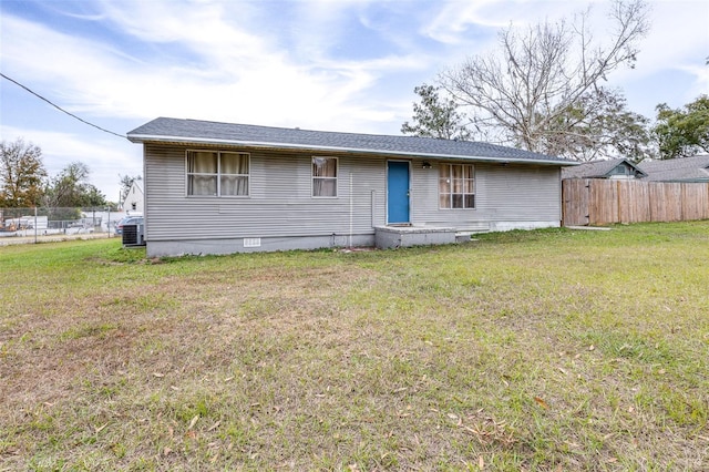 view of front of house featuring a front yard and central AC