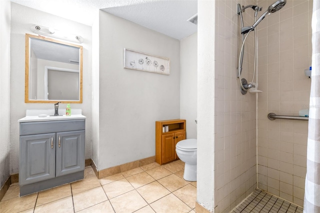 bathroom featuring toilet, a textured ceiling, tile patterned flooring, a shower with curtain, and vanity