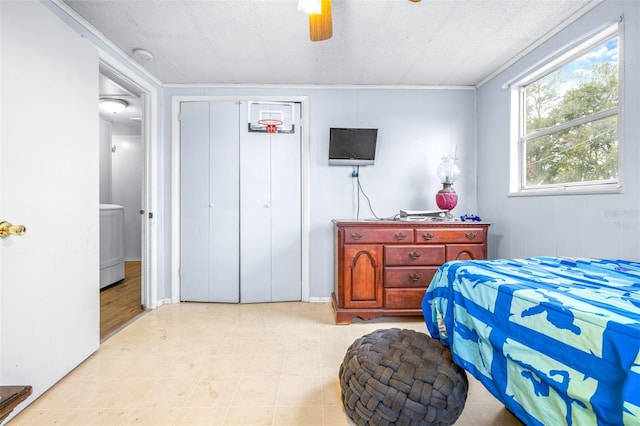 bedroom featuring washer / clothes dryer, a closet, and ceiling fan