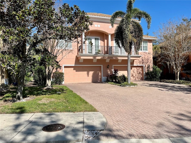 mediterranean / spanish-style home with a balcony and a garage