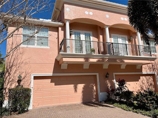 townhome / multi-family property featuring a garage and a balcony