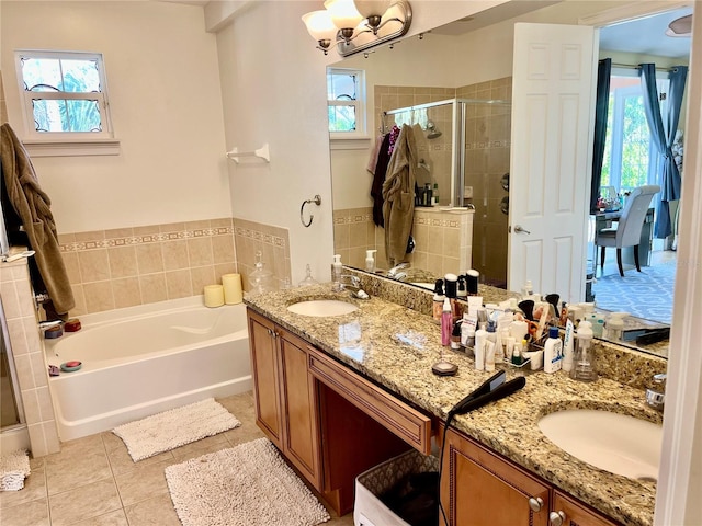 bathroom featuring tile patterned flooring, vanity, plus walk in shower, and a chandelier