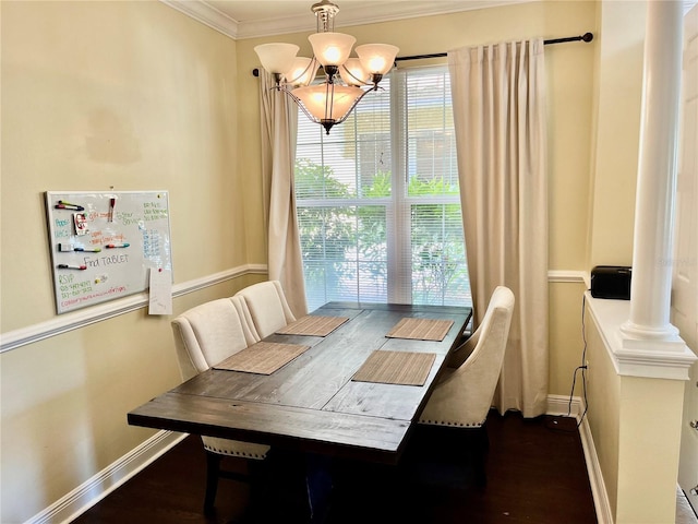 dining space featuring a notable chandelier, crown molding, wood-type flooring, and decorative columns