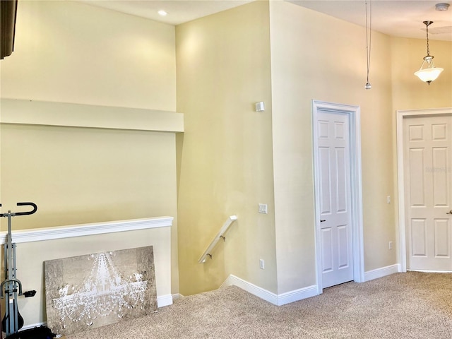 stairway with vaulted ceiling and carpet