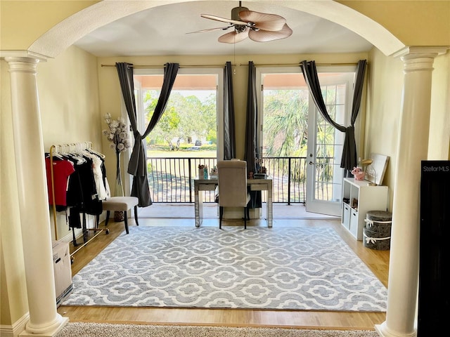 sitting room featuring ornate columns, ceiling fan, and light hardwood / wood-style floors