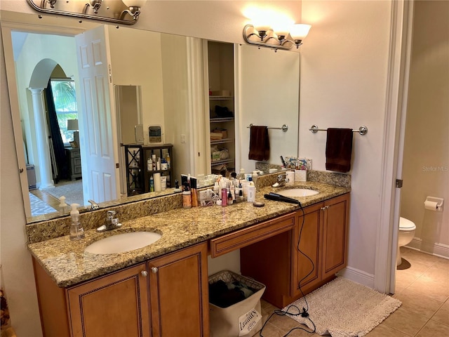 bathroom featuring tile patterned flooring, vanity, and toilet