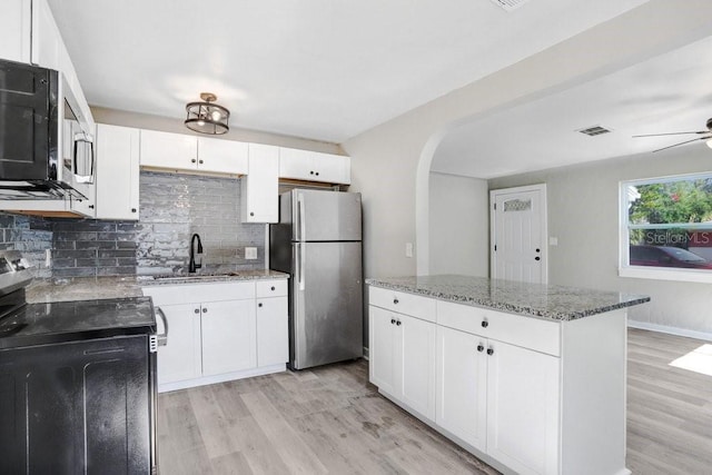 kitchen with sink, white cabinetry, tasteful backsplash, and appliances with stainless steel finishes