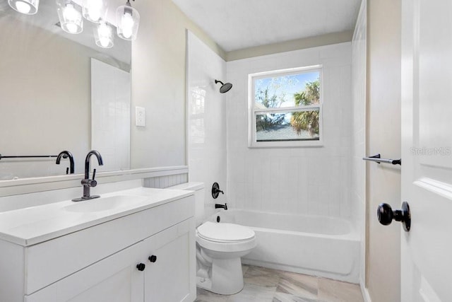 full bathroom with toilet, vanity, and tiled shower / bath combo