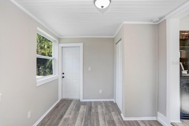 interior space with ornamental molding and light hardwood / wood-style floors