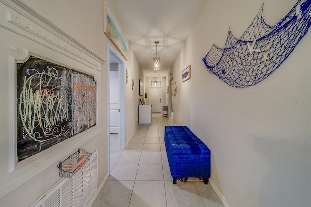 hall featuring light tile patterned flooring