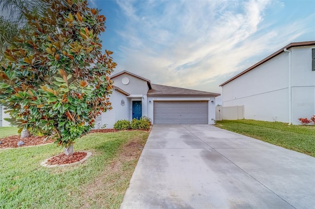 view of front of property with a front yard and a garage