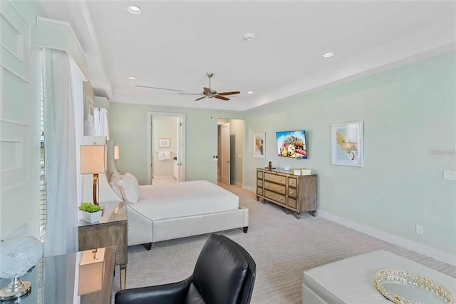 bedroom featuring ensuite bathroom, light carpet, and ceiling fan