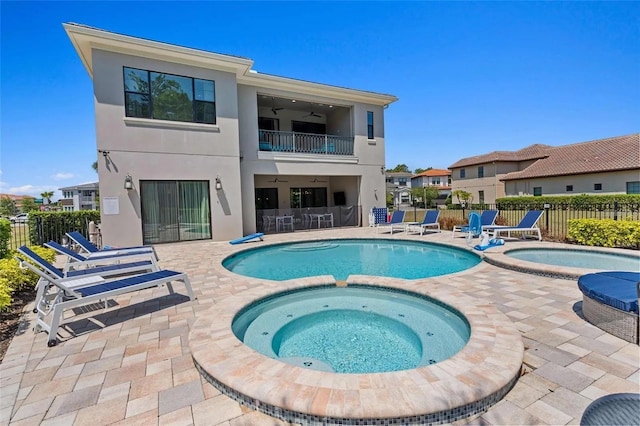 view of swimming pool with a patio area, ceiling fan, and an in ground hot tub