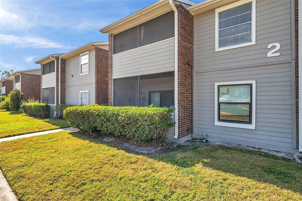 view of home's exterior with a yard