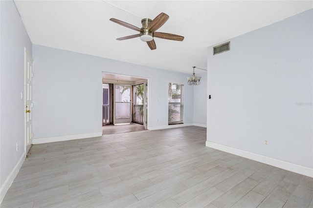 empty room with light hardwood / wood-style floors and ceiling fan with notable chandelier