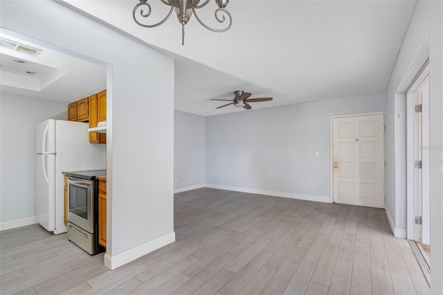 kitchen with ceiling fan with notable chandelier, electric range, white fridge, and light wood-type flooring