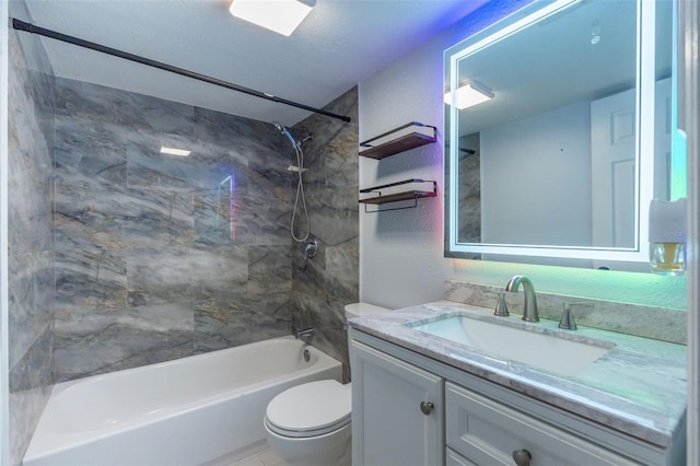 full bathroom featuring toilet, vanity, and tiled shower / bath