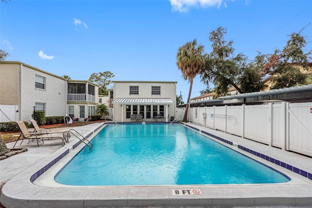 view of pool with a patio and a sunroom