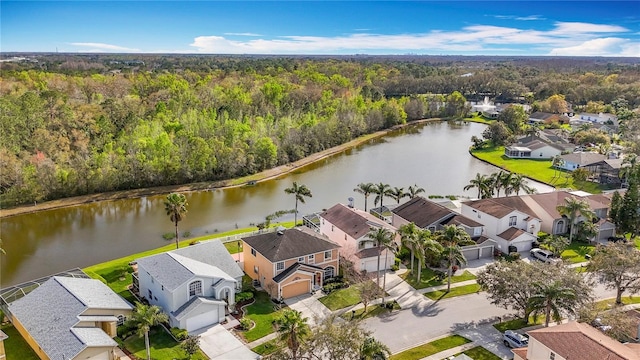 drone / aerial view with a water view, a forest view, and a residential view