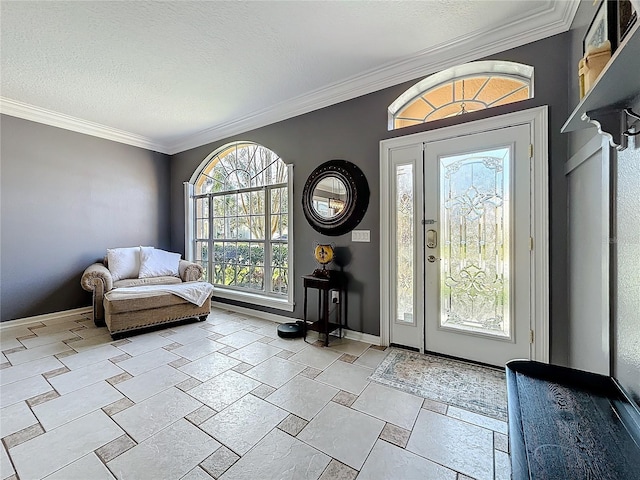 foyer entrance with a textured ceiling, baseboards, and crown molding