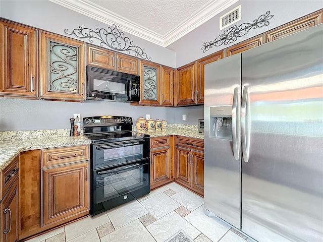 kitchen featuring a textured ceiling, visible vents, ornamental molding, brown cabinets, and black appliances