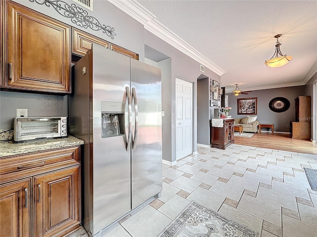 kitchen featuring ceiling fan, a textured ceiling, a toaster, stainless steel fridge with ice dispenser, and crown molding