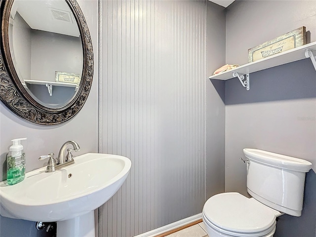 half bathroom with a sink and toilet