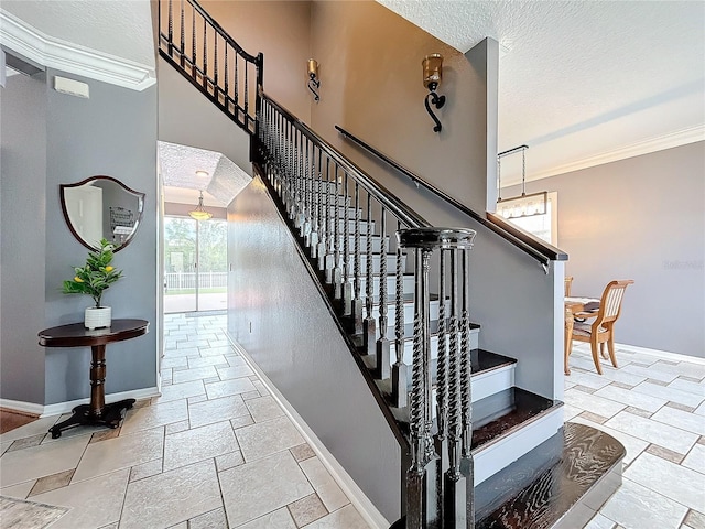 staircase featuring ornamental molding, baseboards, and stone tile floors