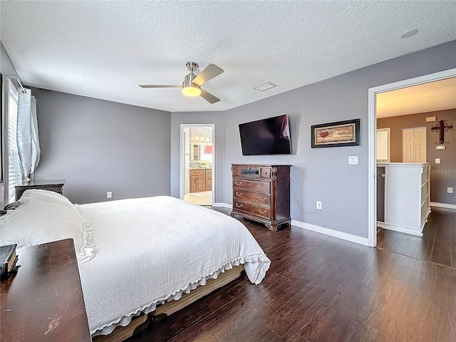 bedroom featuring a ceiling fan, a textured ceiling, baseboards, and wood finished floors