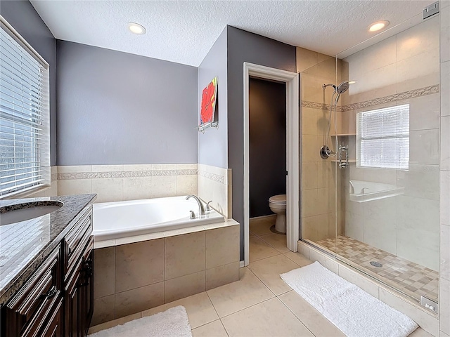 bathroom with a stall shower, tile patterned flooring, toilet, and a bath