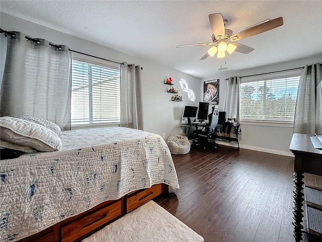 bedroom featuring a ceiling fan, wood-type flooring, baseboards, and a textured ceiling